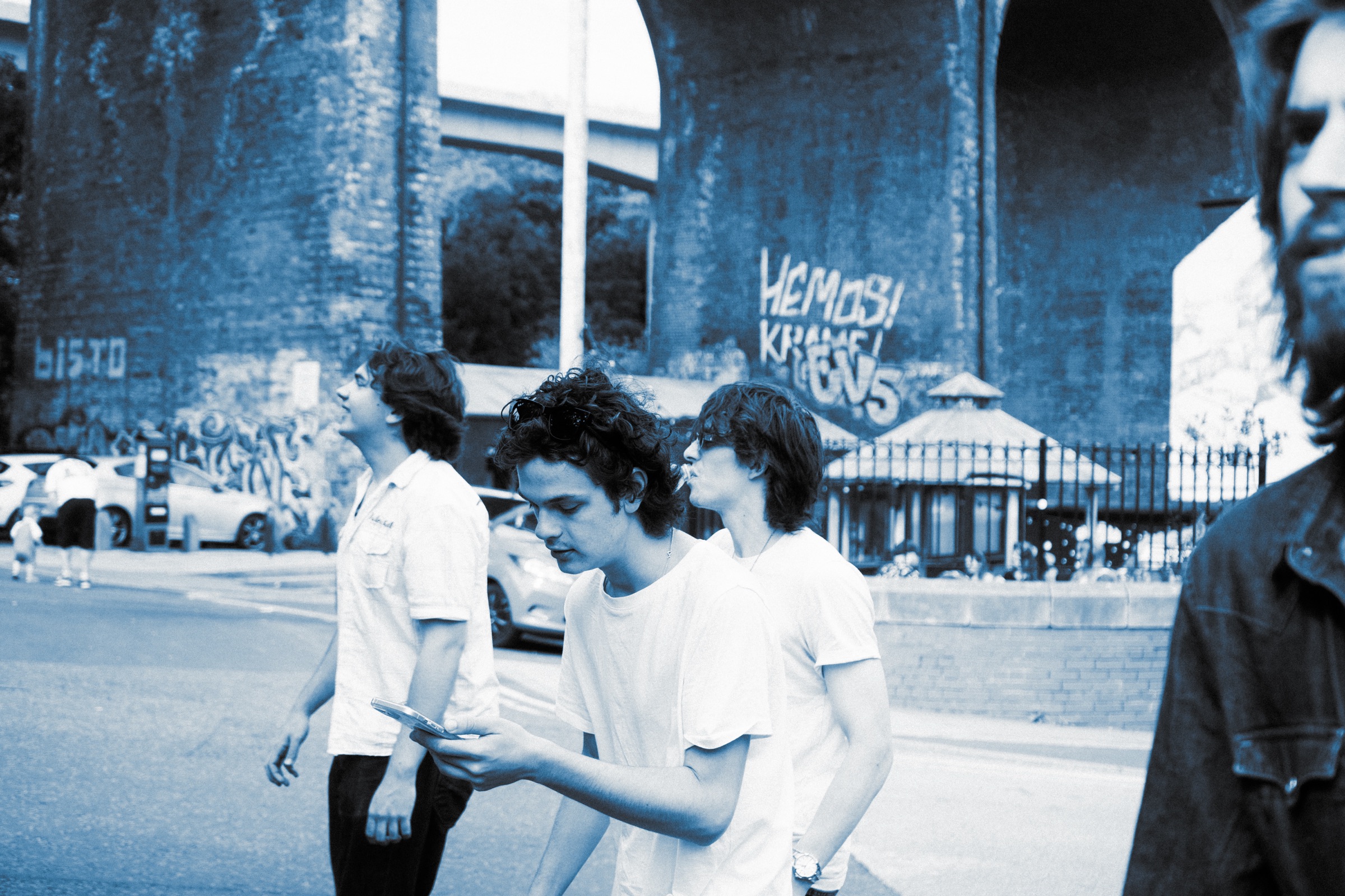 The band walking beneath a brick viaduct